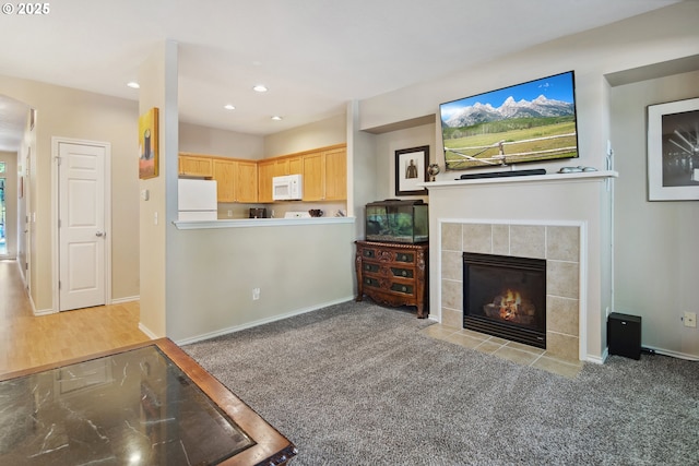 living room with light carpet and a fireplace