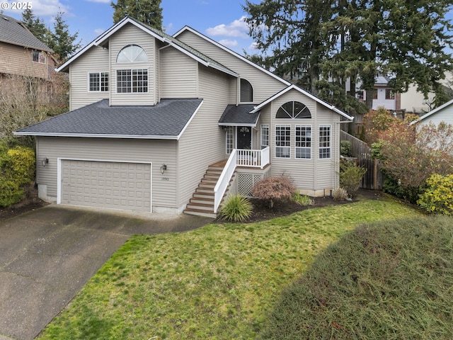 view of front of home featuring a front lawn, stairway, driveway, and roof with shingles