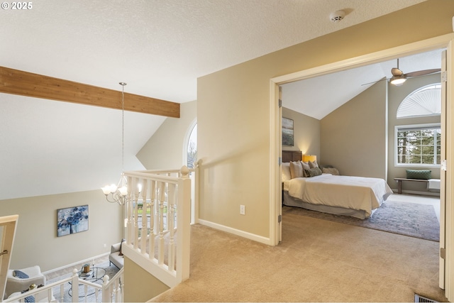 bedroom with lofted ceiling with beams, baseboards, carpet floors, and a textured ceiling