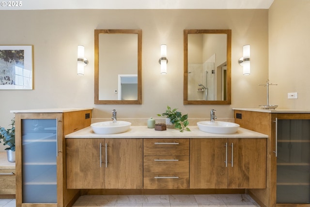 full bath with double vanity, a shower, and a sink