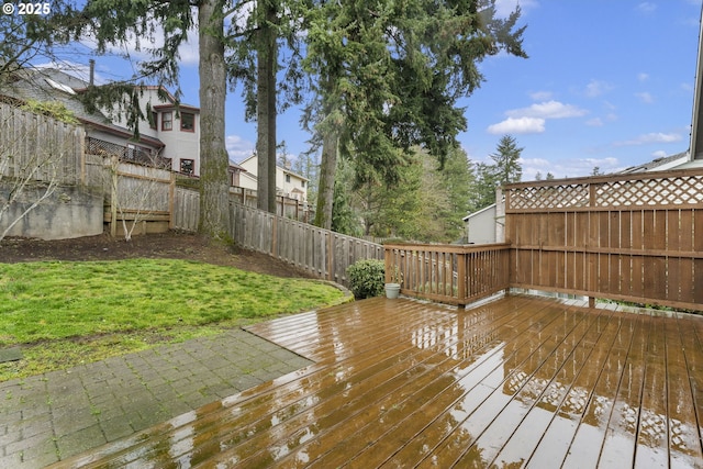 wooden terrace with a yard and a fenced backyard