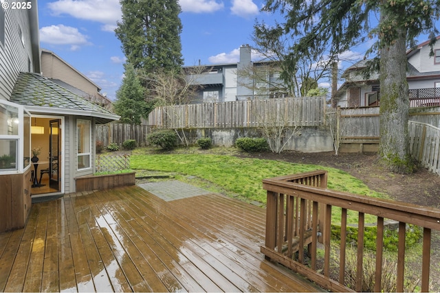 deck featuring a lawn and a fenced backyard