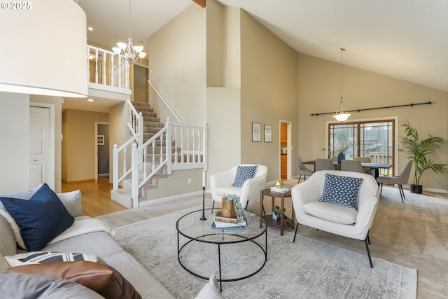 carpeted living area with stairway, a notable chandelier, baseboards, and high vaulted ceiling