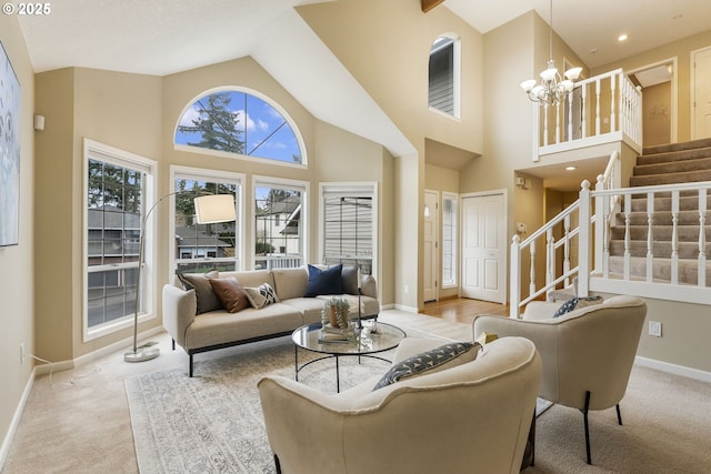 carpeted living room with stairway, baseboards, high vaulted ceiling, and a chandelier