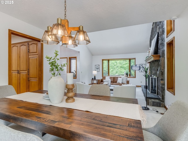 2972 Tolkien Ln, Lake Oswego, OR 97034 - dining area with a stone fireplace, vaulted ceiling, and light colored carpet