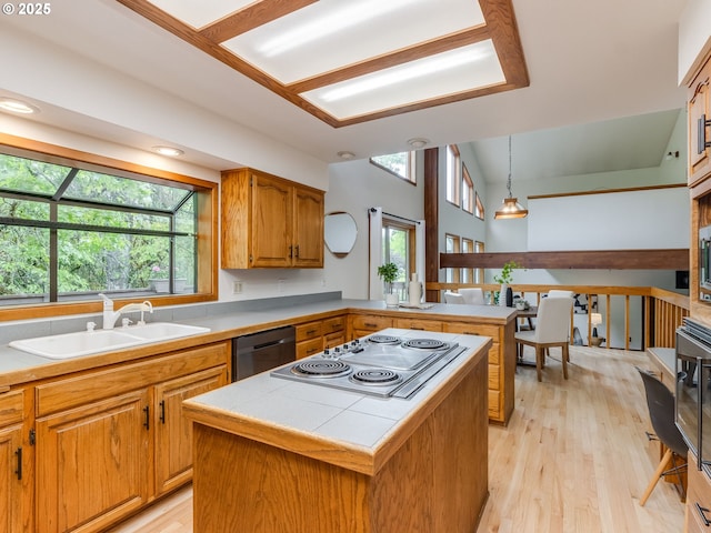 2972 Tolkien Ln, Lake Oswego, OR 97034 - kitchen with a sink, dishwasher, electric cooktop, light wood-type flooring, and decorative light fixtures