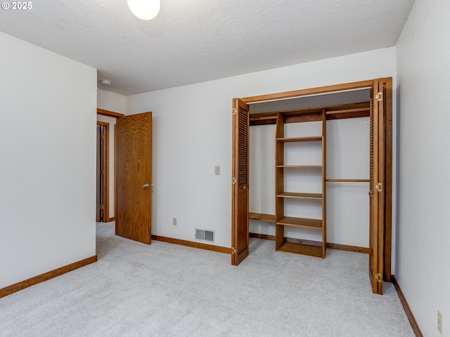 2972 Tolkien Ln, Lake Oswego, OR 97034 - unfurnished bedroom with carpet, a closet, baseboards, and a textured ceiling
