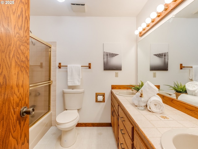 2972 Tolkien Ln, Lake Oswego, OR 97034 - full bathroom featuring double vanity, toilet, baseboards, tile patterned floors, and enclosed tub / shower combo