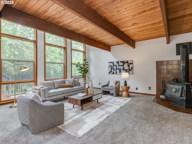 2972 Tolkien Ln, Lake Oswego, OR 97034 - carpeted living area with a wood stove, plenty of natural light, wood ceiling with exposed beams, and baseboards