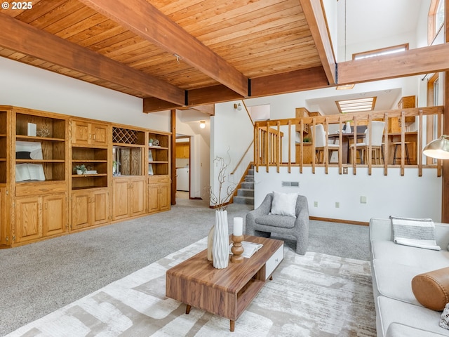 2972 Tolkien Ln, Lake Oswego, OR 97034 - living room with light carpet, wood ceiling with exposed beams, washer / clothes dryer, stairs, and a skylight