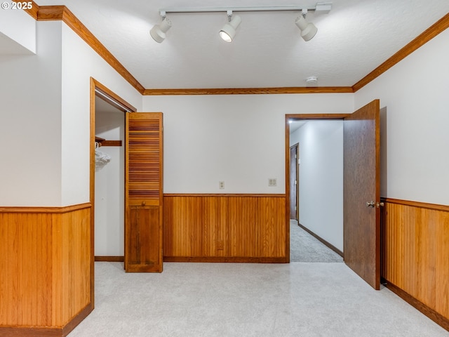 2972 Tolkien Ln, Lake Oswego, OR 97034 - spare room with a wainscoted wall, wooden walls, light colored carpet, and crown molding