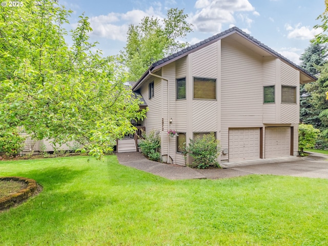2972 Tolkien Ln, Lake Oswego, OR 97034 - view of side of home with an attached garage, concrete driveway, and a lawn