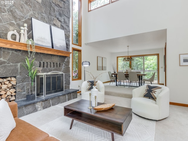 2972 Tolkien Ln, Lake Oswego, OR 97034 - living room with a stone fireplace, baseboards, a towering ceiling, and carpet