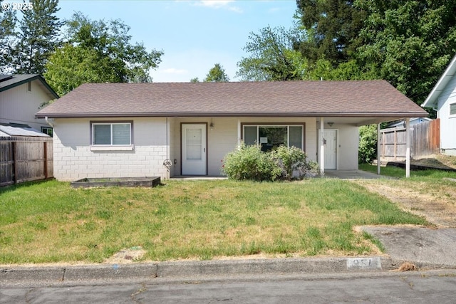 single story home featuring fence, a carport, and a front lawn