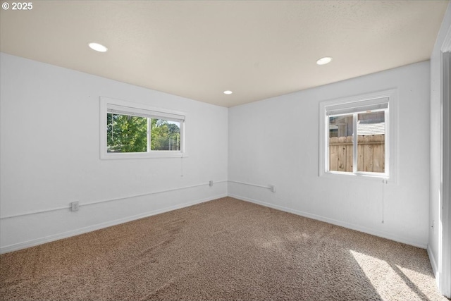 empty room with carpet floors, baseboards, and recessed lighting
