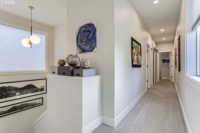 hallway with light colored carpet