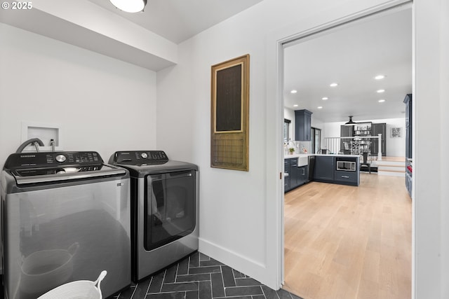 clothes washing area featuring washer and dryer, recessed lighting, and baseboards