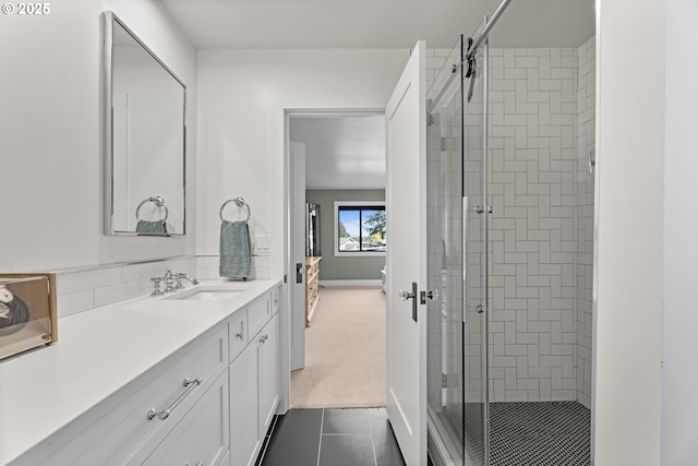 bathroom featuring a shower stall, tile patterned floors, vanity, and baseboards