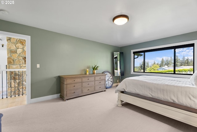 bedroom with baseboards and carpet