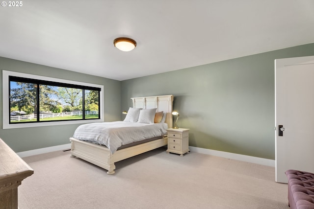 carpeted bedroom featuring baseboards