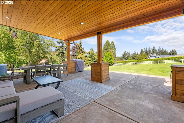 view of patio featuring outdoor dining space and fence