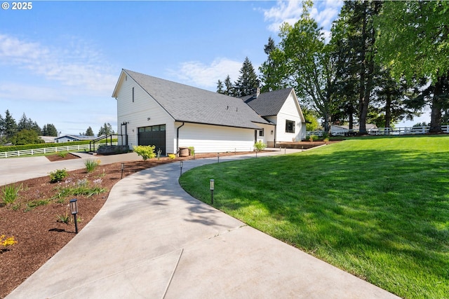 view of side of home featuring a garage and driveway