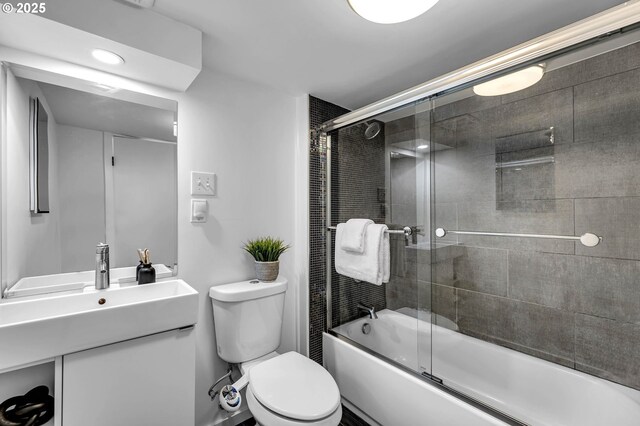 6206 N Denver Ave, Portland, OR 97217 - full bathroom with toilet, vanity, and bath / shower combo with glass door