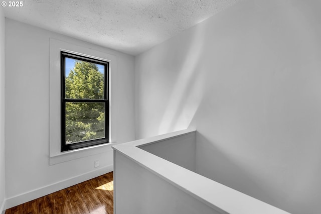6206 N Denver Ave, Portland, OR 97217 - hallway featuring a textured ceiling, dark wood-style floors, and baseboards