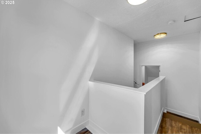 6206 N Denver Ave, Portland, OR 97217 - hallway with an upstairs landing, baseboards, wood finished floors, and a textured ceiling