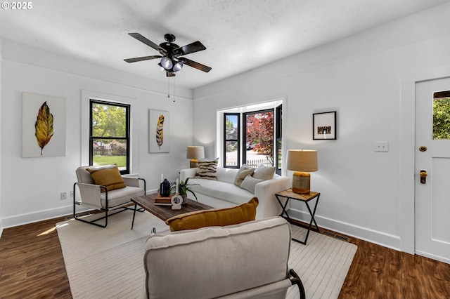 6206 N Denver Ave, Portland, OR 97217 - living area featuring baseboards, healthy amount of natural light, dark wood finished floors, and ceiling fan
