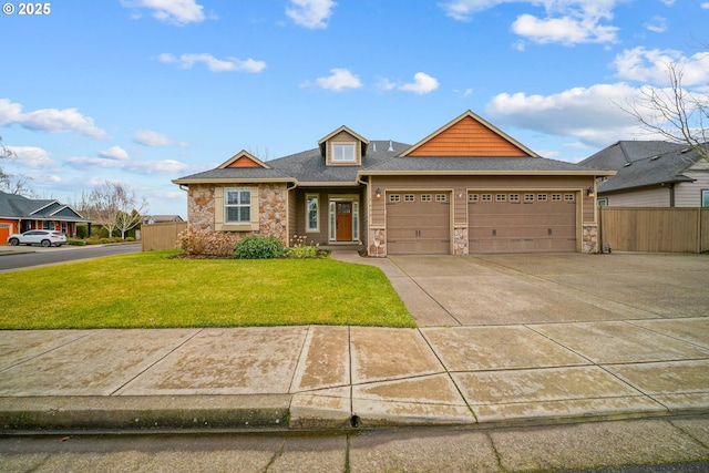 view of front of property featuring a garage and a front lawn