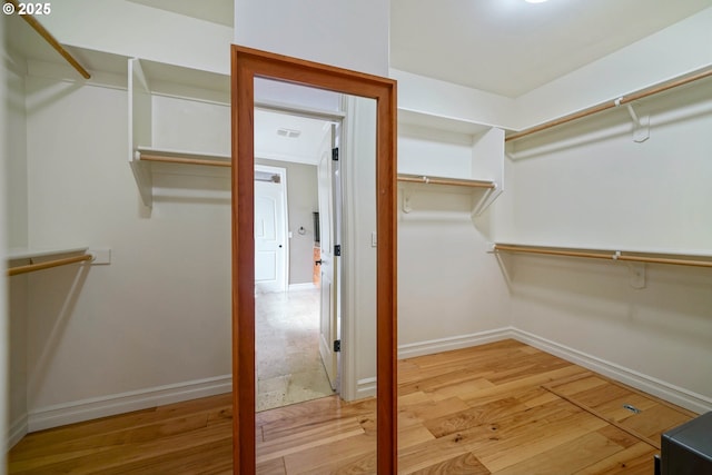 walk in closet featuring hardwood / wood-style flooring