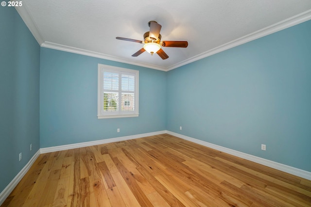 empty room with ornamental molding, ceiling fan, and light wood-type flooring