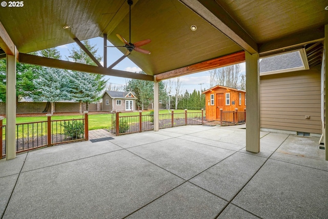 view of patio / terrace with ceiling fan and a storage unit