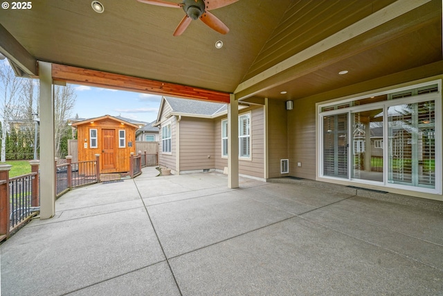 view of patio / terrace with ceiling fan and a storage shed