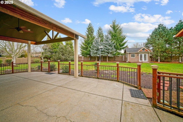 view of patio featuring an outbuilding and ceiling fan