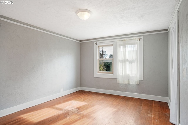 1825 NE 4th St, Salem, OR 97301 - unfurnished room featuring hardwood / wood-style floors, crown molding, a textured wall, and a textured ceiling