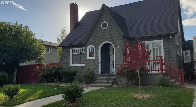 1825 NE 4th St, Salem, OR 97301 - tudor-style house featuring a chimney, a front yard, and roof with shingles