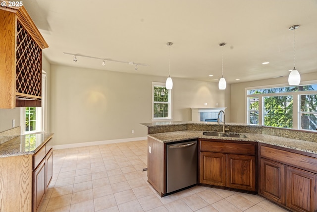 1748 Hardin Ave NW, Salem, OR 97304 - kitchen featuring stainless steel dishwasher, a sink, a fireplace, healthy amount of natural light, and recessed lighting