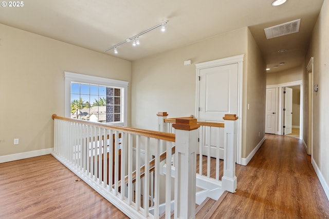 1748 Hardin Ave NW, Salem, OR 97304 - hallway with an upstairs landing, wood finished floors, baseboards, and track lighting