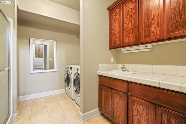 1748 Hardin Ave NW, Salem, OR 97304 - washroom with a sink, washing machine and clothes dryer, light tile patterned floors, and baseboards