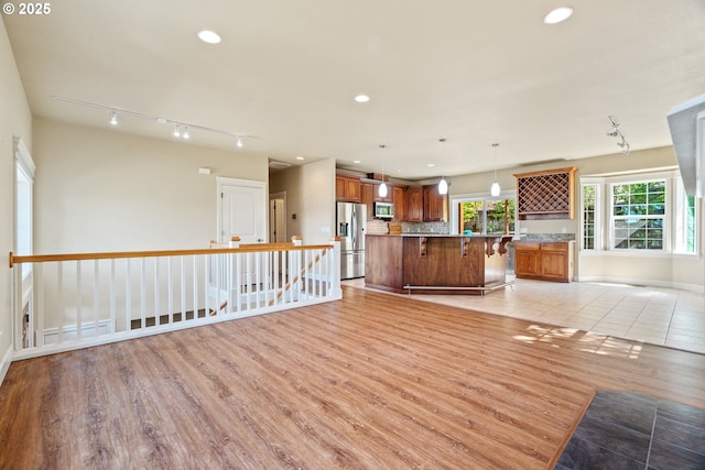 1748 Hardin Ave NW, Salem, OR 97304 - unfurnished living room featuring light wood-style flooring, recessed lighting, baseboards, and track lighting