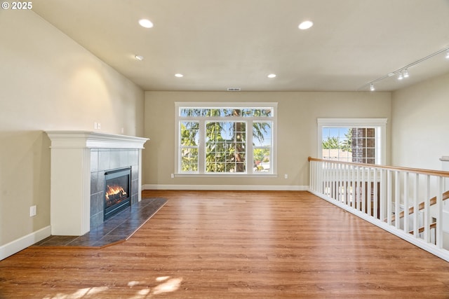 1748 Hardin Ave NW, Salem, OR 97304 - unfurnished living room featuring a fireplace, wood finished floors, track lighting, recessed lighting, and baseboards