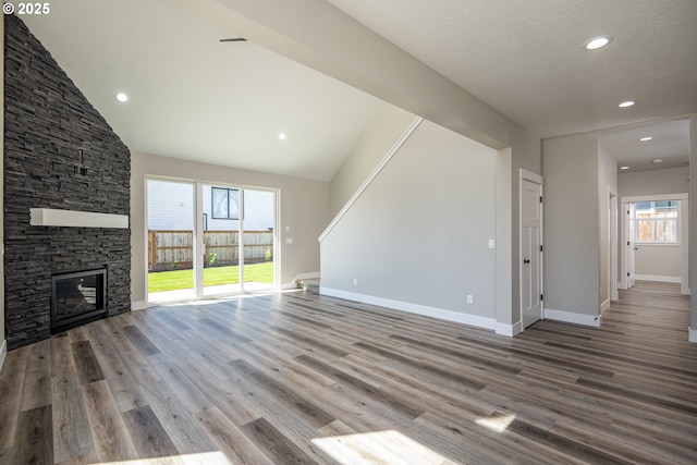 24934 Westfield Ave, Veneta, OR 97487 - unfurnished living room with wood finished floors, a stone fireplace, and recessed lighting