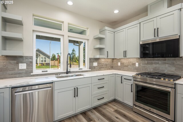 24934 Westfield Ave, Veneta, OR 97487 - kitchen with open shelves, appliances with stainless steel finishes, recessed lighting, light stone countertops, and light wood finished floors