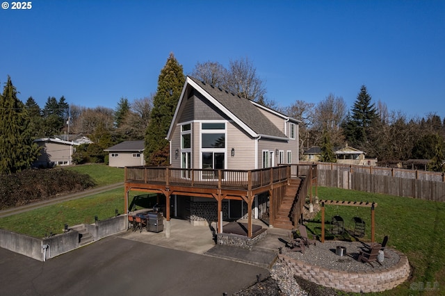 rear view of house featuring a deck, a yard, stairway, and a patio area