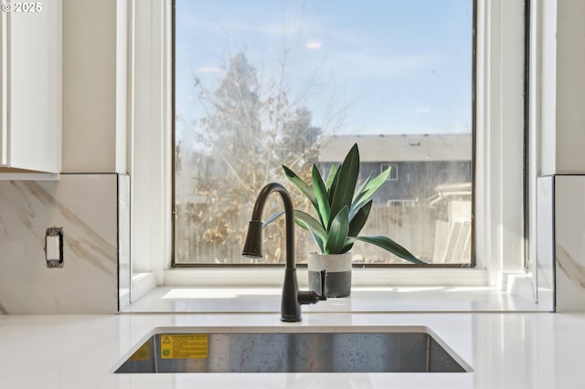 room details with white cabinets and a sink