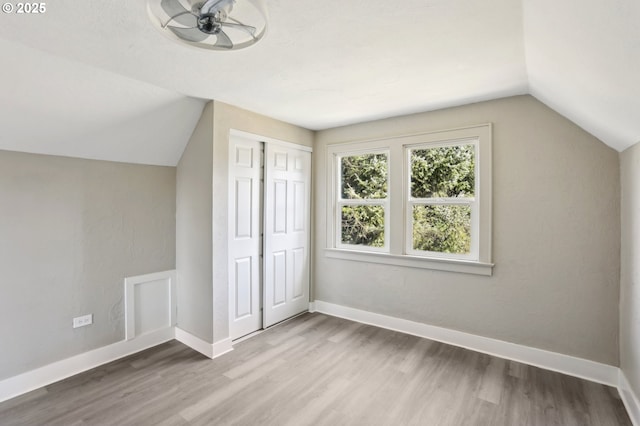 bonus room with lofted ceiling, wood finished floors, and baseboards