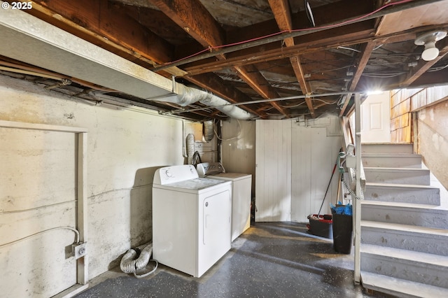 unfinished below grade area featuring stairway and independent washer and dryer