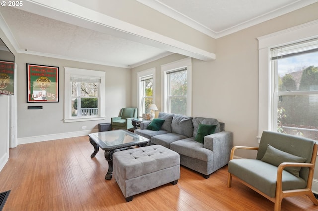 living area featuring plenty of natural light, baseboards, light wood-type flooring, and ornamental molding